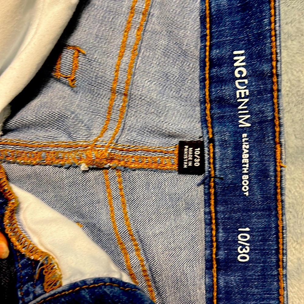 INC Elizabeth bootcut jeans with fringe hem.